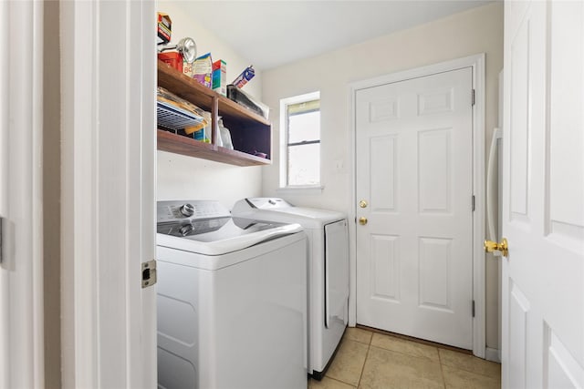 laundry room with light tile patterned floors and independent washer and dryer