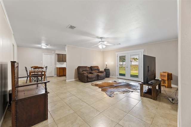 living room with ceiling fan, french doors, light tile patterned floors, and ornamental molding