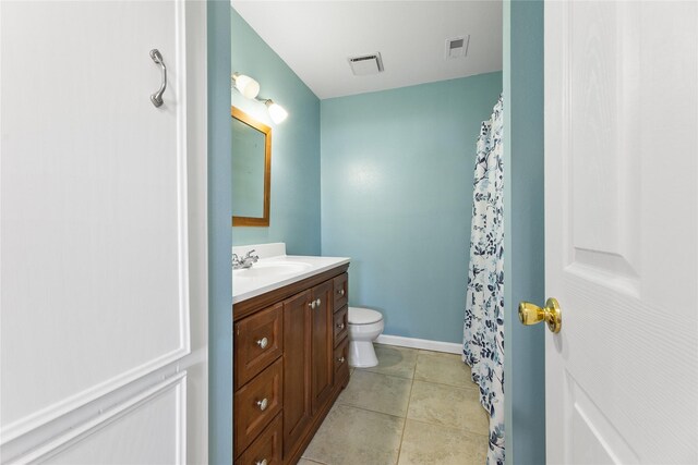 bathroom with curtained shower, tile patterned flooring, vanity, and toilet