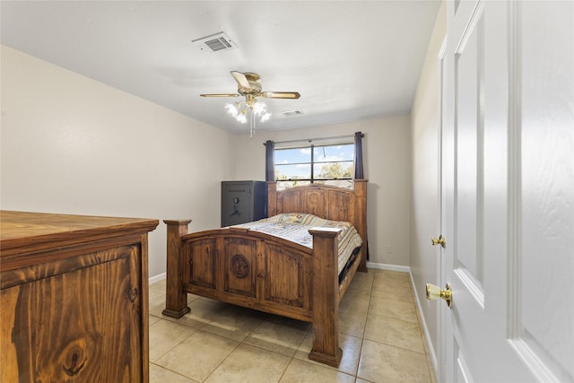 bedroom with a ceiling fan, light tile patterned flooring, visible vents, and baseboards