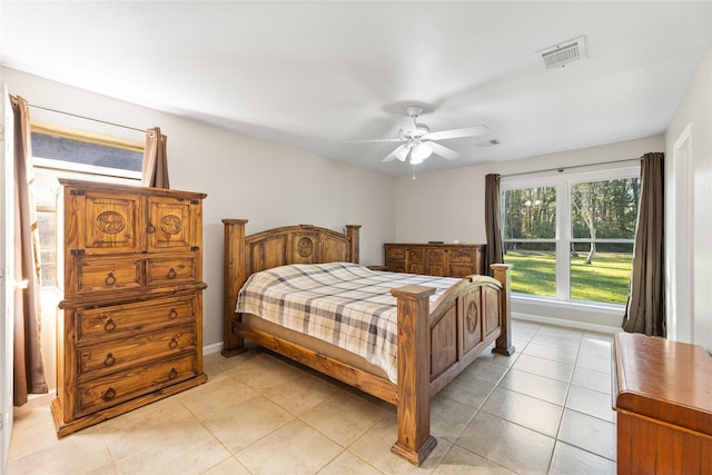 bedroom with visible vents, ceiling fan, baseboards, and light tile patterned flooring