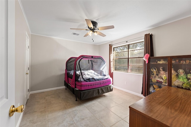 bedroom with light tile patterned floors, a ceiling fan, baseboards, visible vents, and crown molding