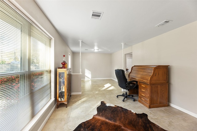 office featuring baseboards, visible vents, and light tile patterned flooring