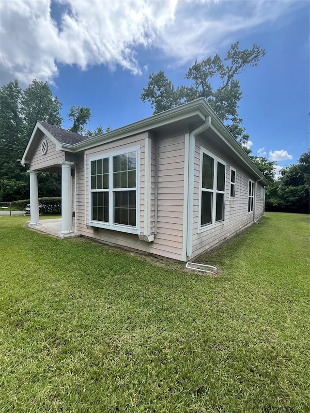 view of property exterior featuring a lawn