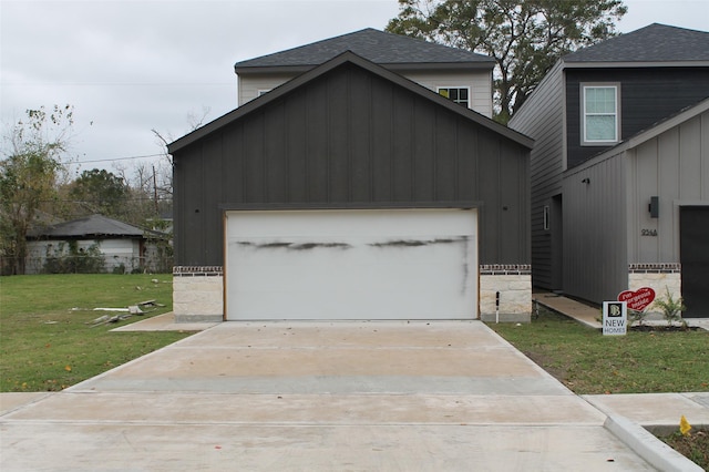 view of front of home with a garage and a front lawn