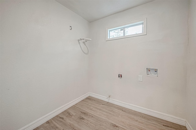 clothes washing area with gas dryer hookup, washer hookup, and light hardwood / wood-style floors