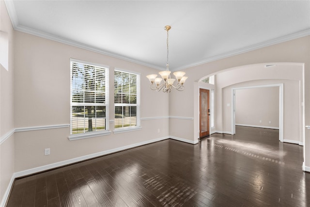 unfurnished room with crown molding, dark hardwood / wood-style floors, and a chandelier