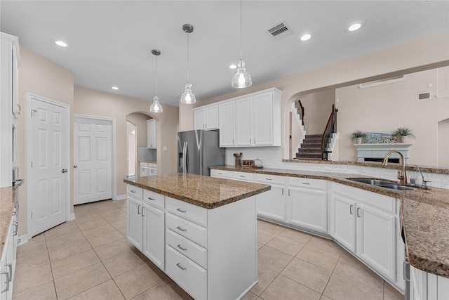 kitchen featuring white cabinetry, stainless steel fridge with ice dispenser, and sink