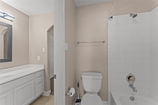 full bathroom featuring tiled shower / bath combo, vanity, tile patterned flooring, and toilet