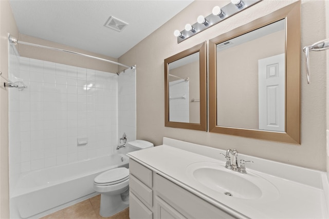 full bathroom featuring tile patterned flooring, vanity, tiled shower / bath combo, and toilet