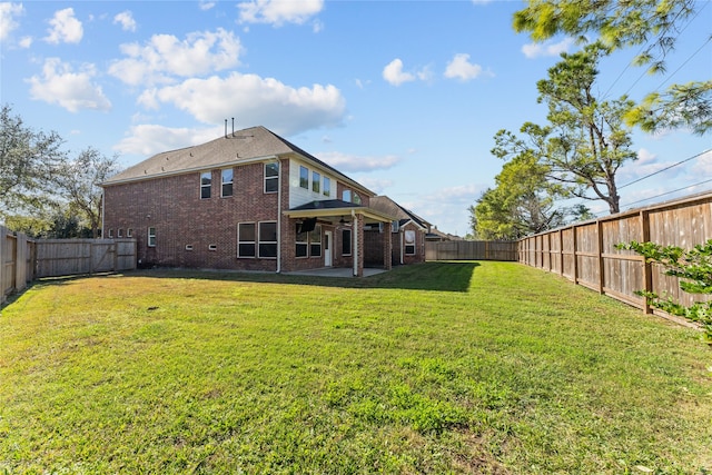 back of house with a patio area and a lawn