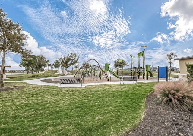 view of property's community featuring a yard and a playground