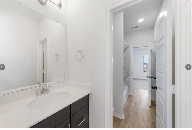 bathroom with vanity and a shower