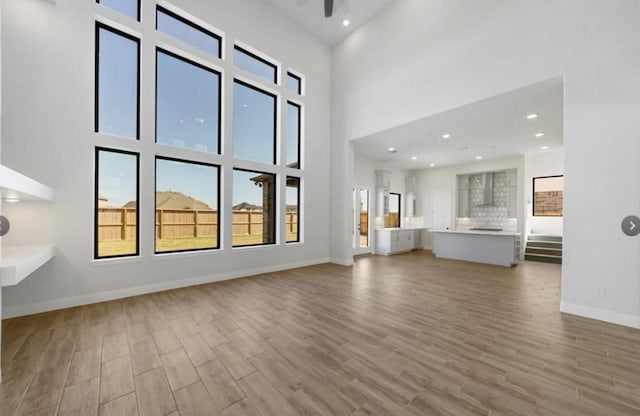 unfurnished living room with a towering ceiling