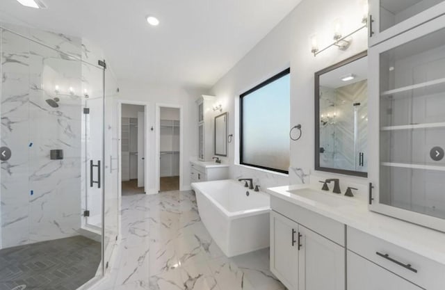 bathroom featuring vanity and independent shower and bath