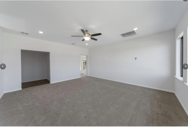 empty room featuring dark colored carpet and ceiling fan