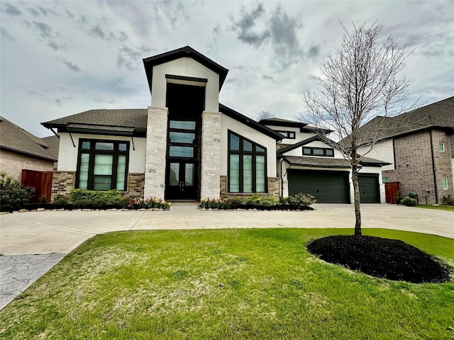 view of front of home with a front lawn and a garage