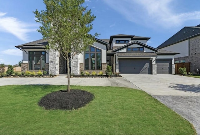 view of front of house with a garage and a front lawn