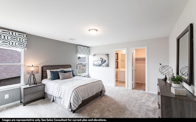 bedroom with ensuite bath, a spacious closet, a closet, and light carpet