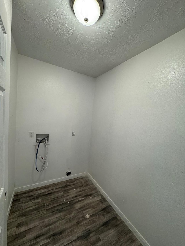 washroom with electric dryer hookup, dark wood-type flooring, washer hookup, and a textured ceiling