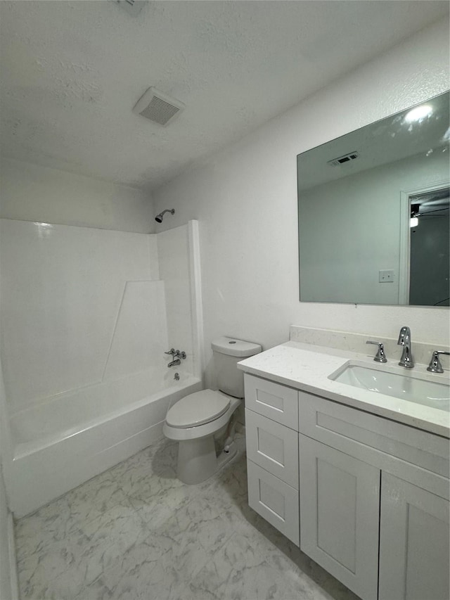 full bathroom with vanity, a textured ceiling,  shower combination, and toilet