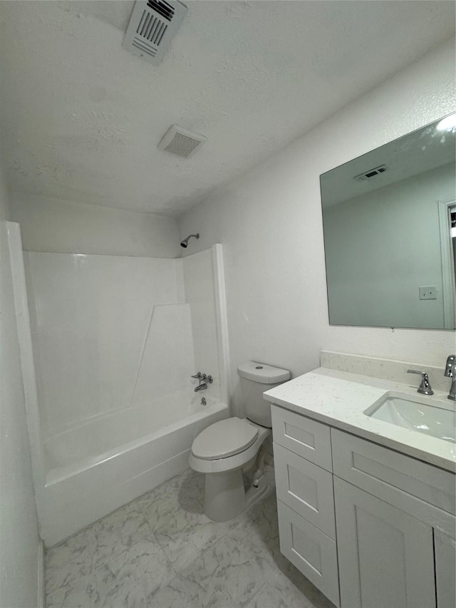 full bathroom featuring a textured ceiling, vanity, toilet, and shower / washtub combination