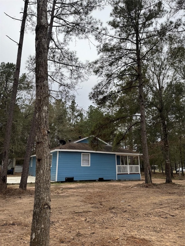 view of side of home with a porch