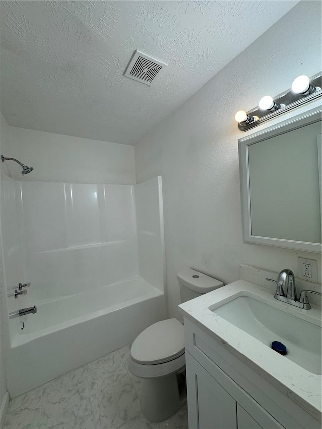 full bathroom featuring bathing tub / shower combination, vanity, a textured ceiling, and toilet