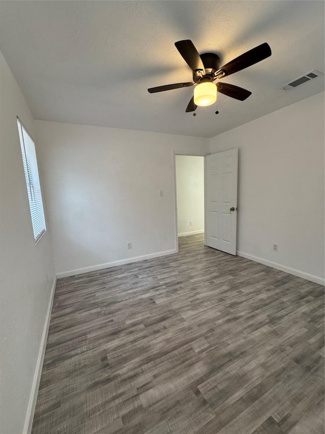 unfurnished room featuring dark hardwood / wood-style floors and ceiling fan