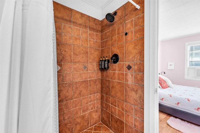 bathroom with crown molding and walk in shower