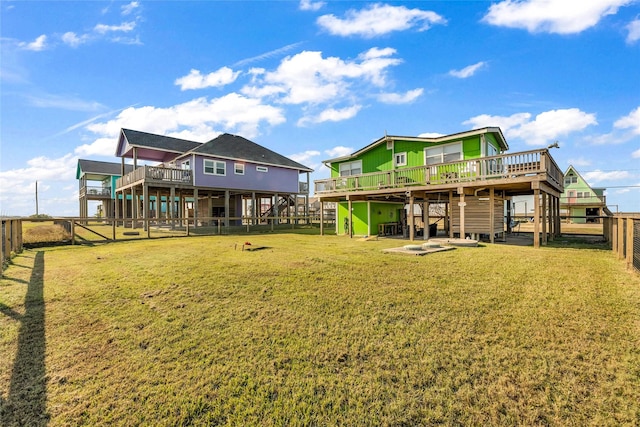 back of house featuring a yard and a wooden deck