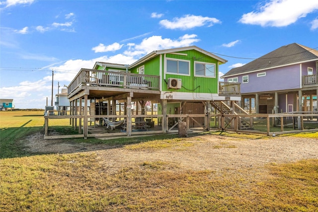 rear view of house with a lawn and a deck