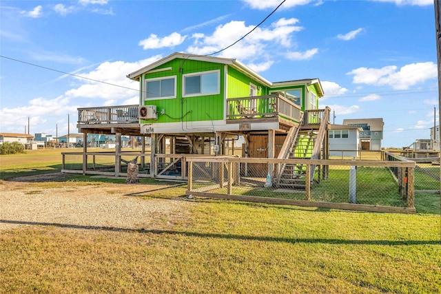 exterior space featuring ac unit, a yard, and a wooden deck