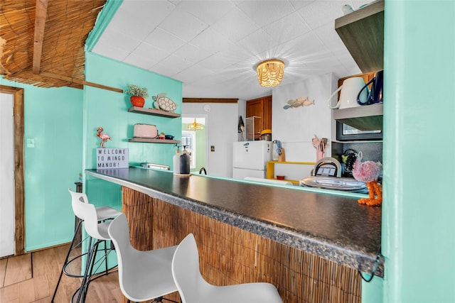 kitchen featuring light wood-type flooring and white refrigerator