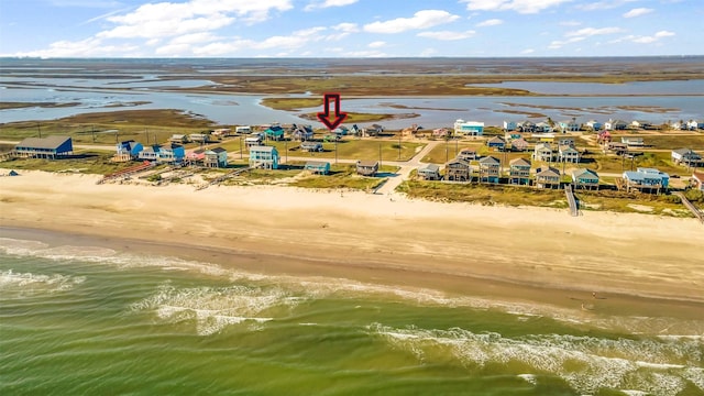 drone / aerial view featuring a water view and a view of the beach