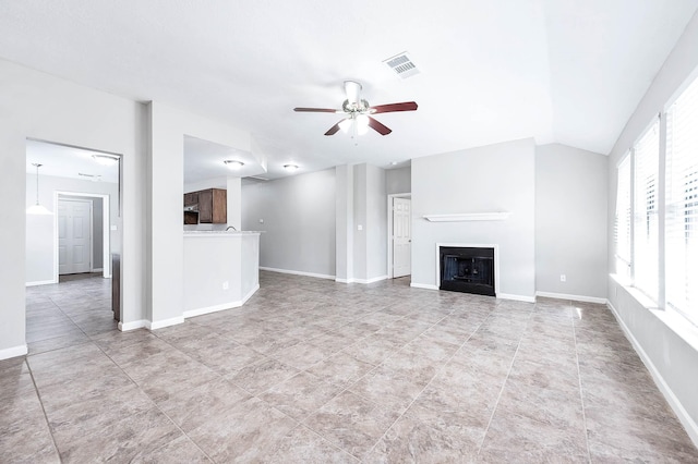 unfurnished living room with ceiling fan and lofted ceiling