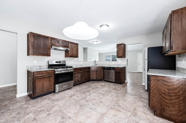 kitchen featuring dark brown cabinets, sink, stainless steel appliances, and decorative light fixtures