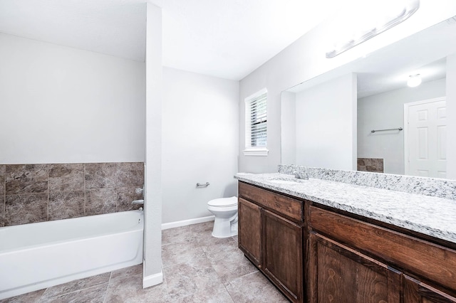 bathroom with a tub, vanity, and toilet