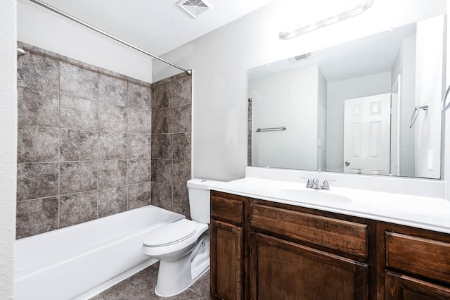 full bathroom featuring tile patterned flooring, vanity, toilet, and tiled shower / bath combo