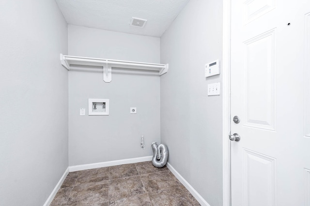 laundry room with electric dryer hookup, hookup for a washing machine, and a textured ceiling