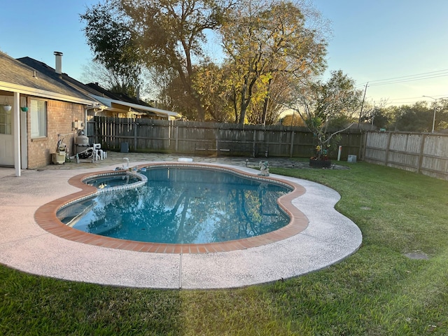 view of swimming pool with a yard and a patio