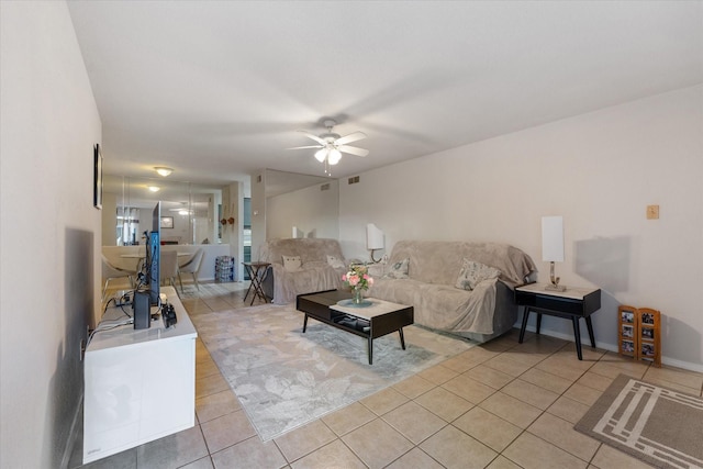 living room with ceiling fan and light tile patterned flooring