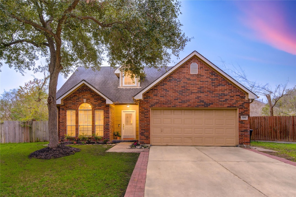 view of property with a yard and a garage