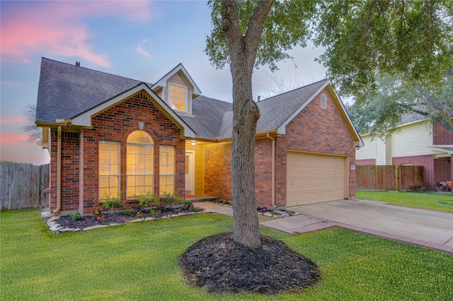 view of front of home with a lawn and a garage