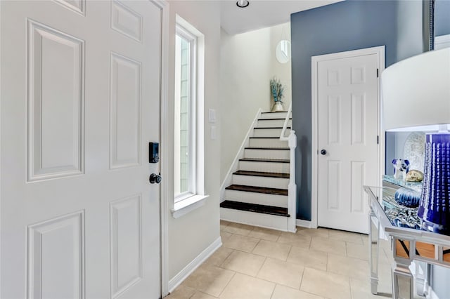 foyer entrance with light tile patterned flooring