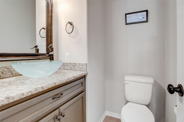 bathroom with tile patterned floors, vanity, and toilet