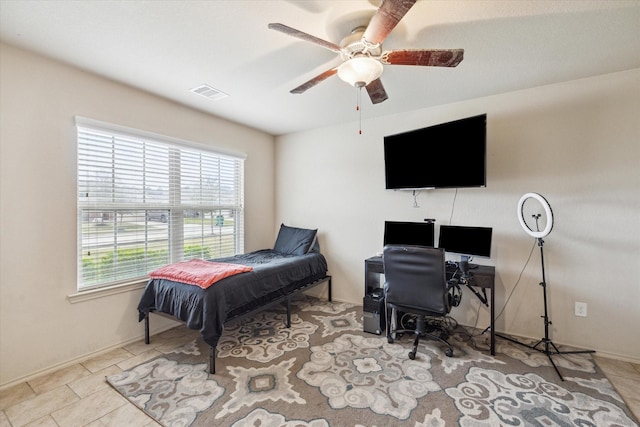 bedroom featuring light tile patterned floors and ceiling fan