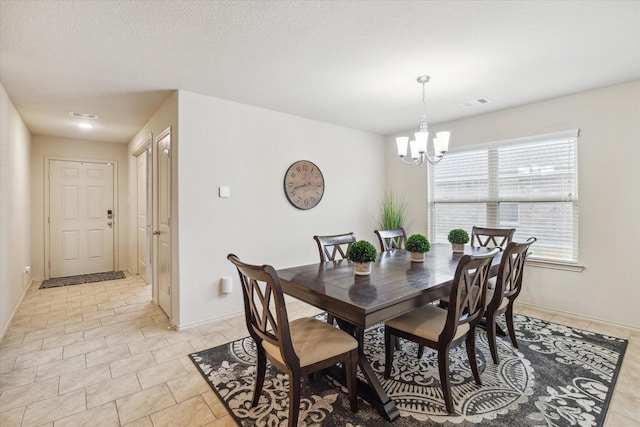 tiled dining area featuring a notable chandelier