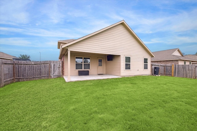 back of property featuring a lawn and a patio