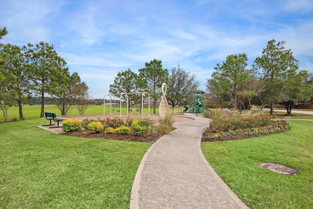 surrounding community featuring a playground and a lawn